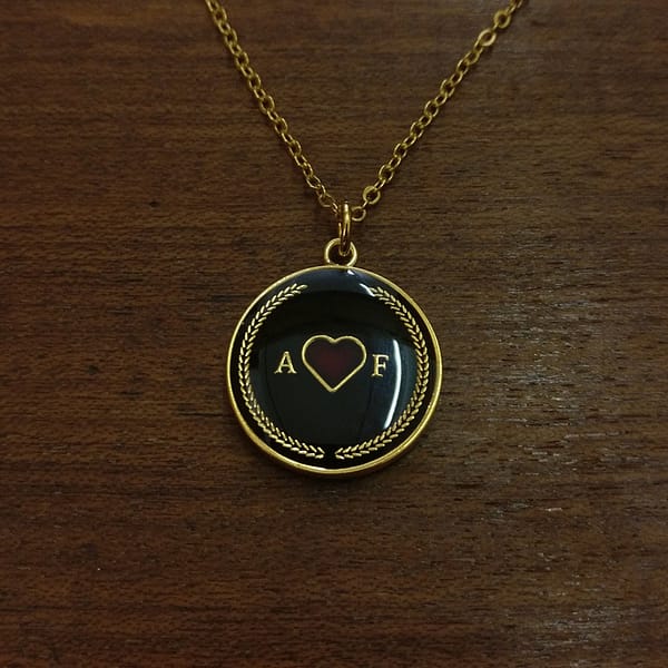amor-fati-gold-and-black-enamelled-pendant-necklace